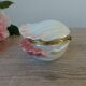 Vintage shell-shaped catchall in iridescent cream and pink ceramic.