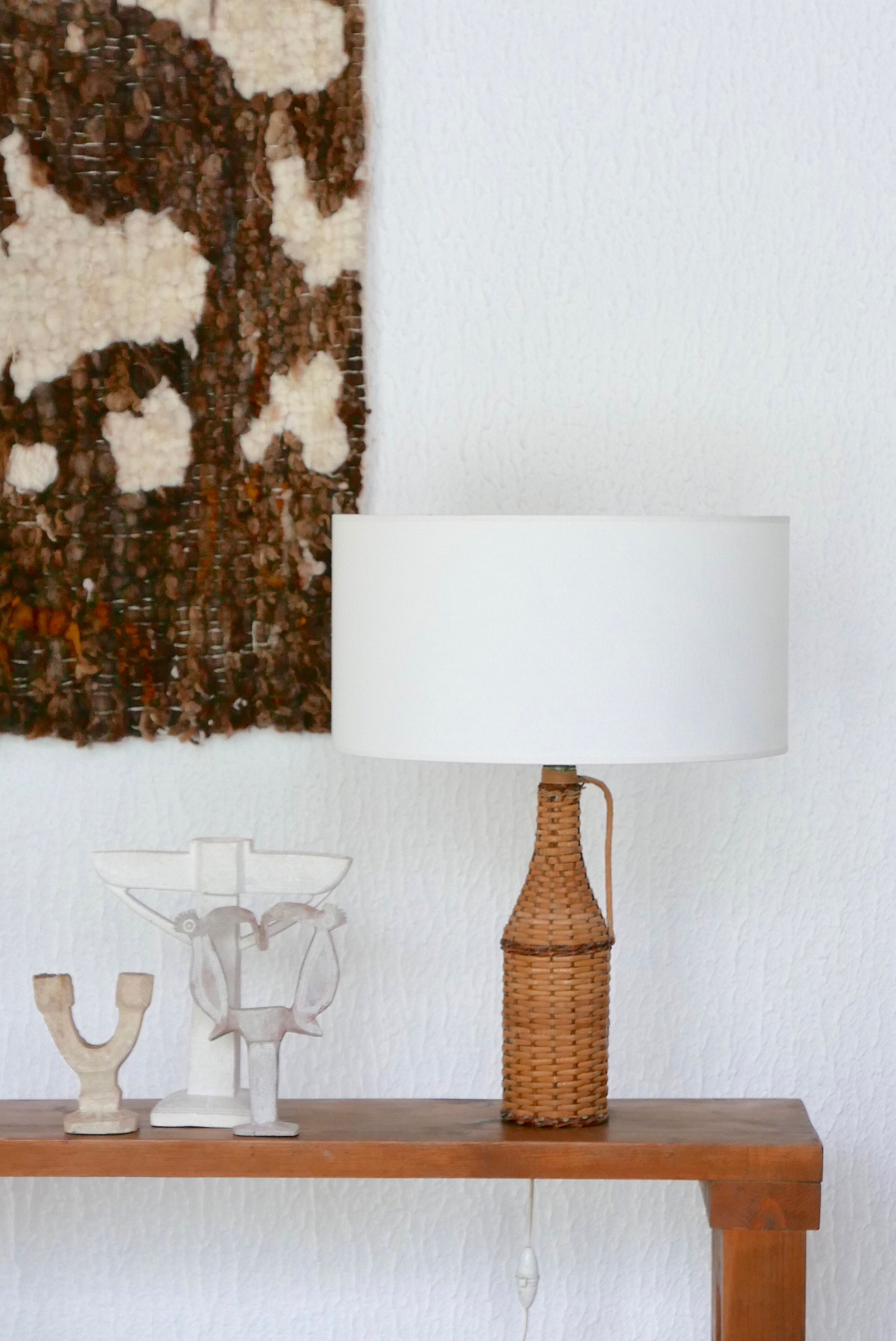 bottle lamp covered with wicker, white drum lampshade, 70s
