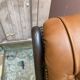 Chesterfield armchair in leather and carved solid wood