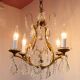 Old French chandelier in gilded brass with tassels