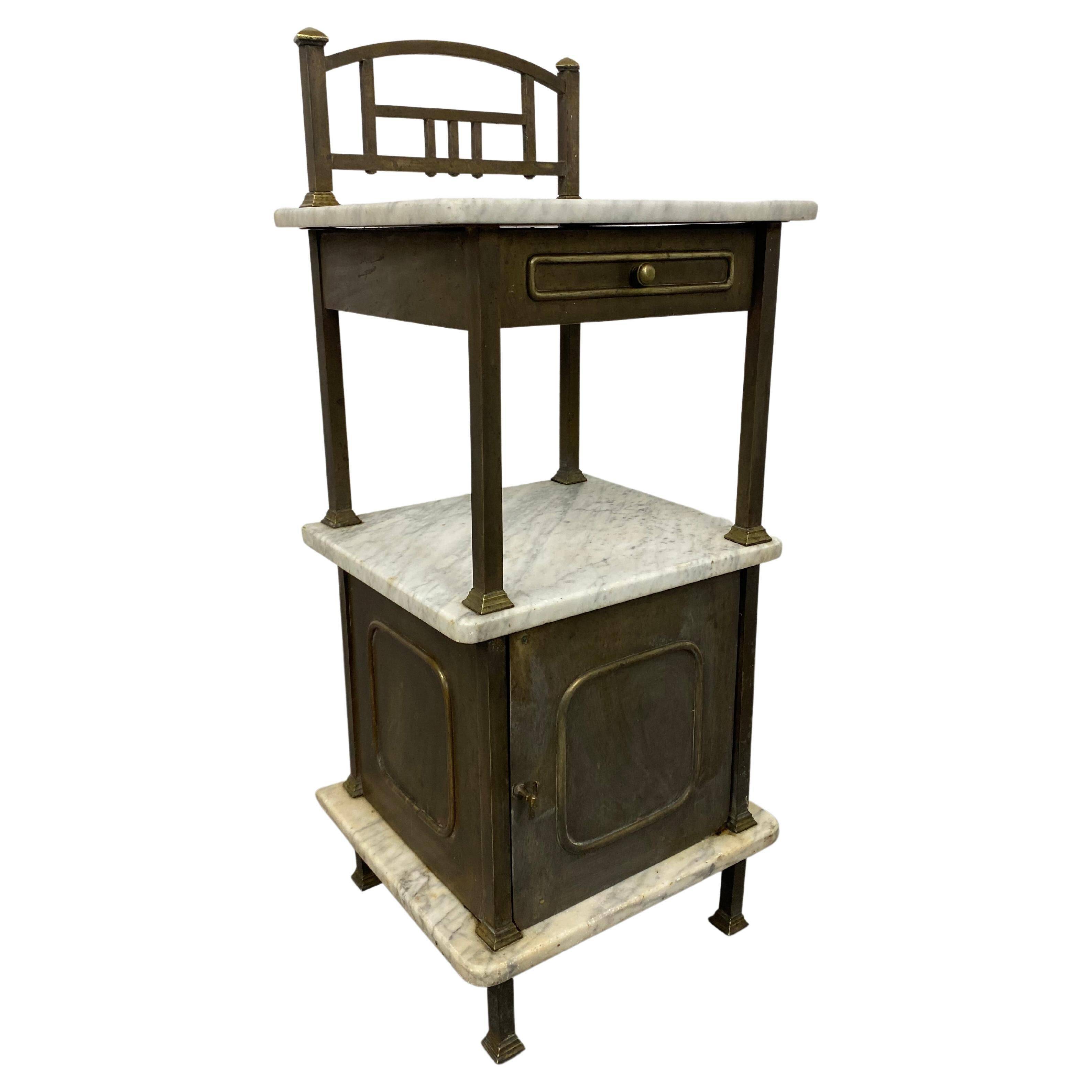 Brass bedside table with a marble top.