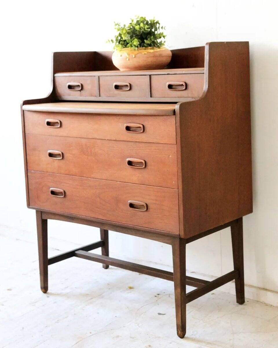 Mid-century teak dressing table in curved brown with sliding mirror and 6 drawers.