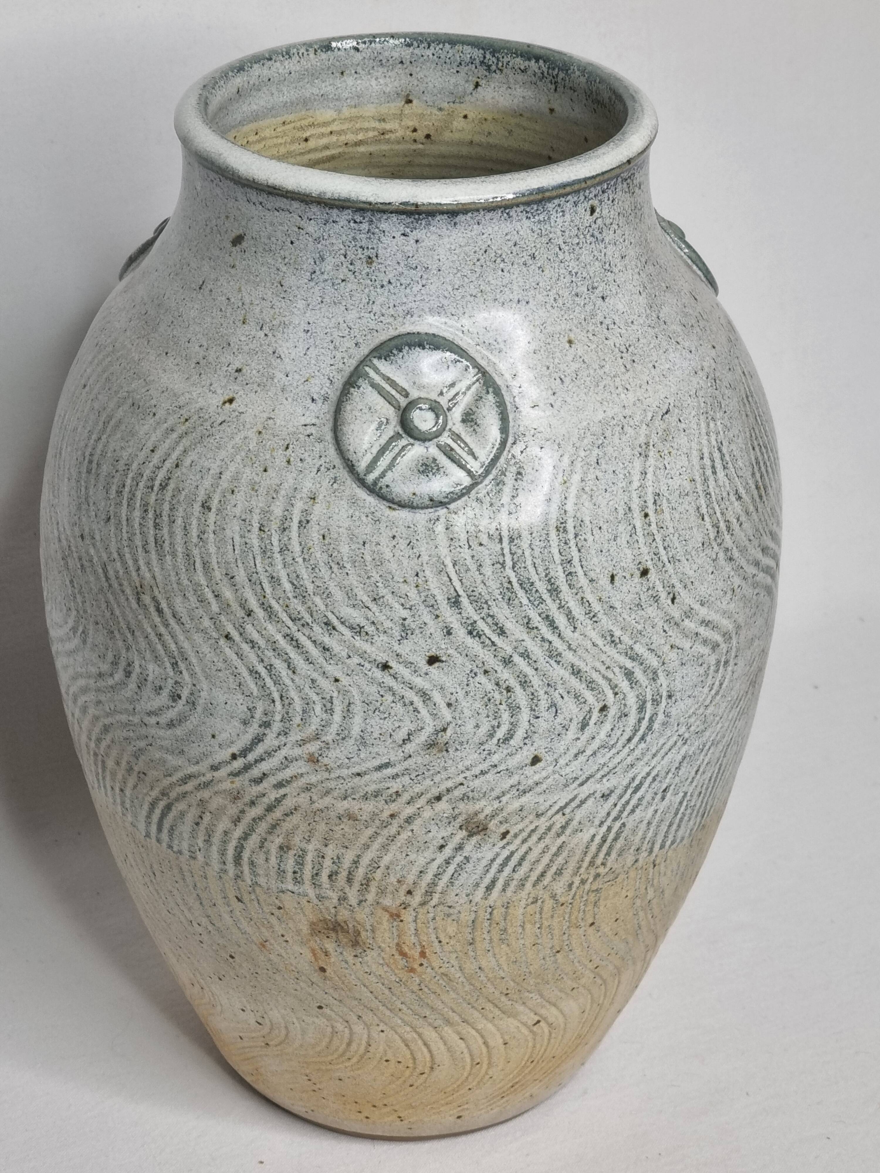Stoneware vase signed by Sylvie Dufour, incised decoration and relief medallions, 28 cm.