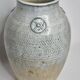 Stoneware vase signed by Sylvie Dufour, incised decoration and relief medallions, 28 cm.