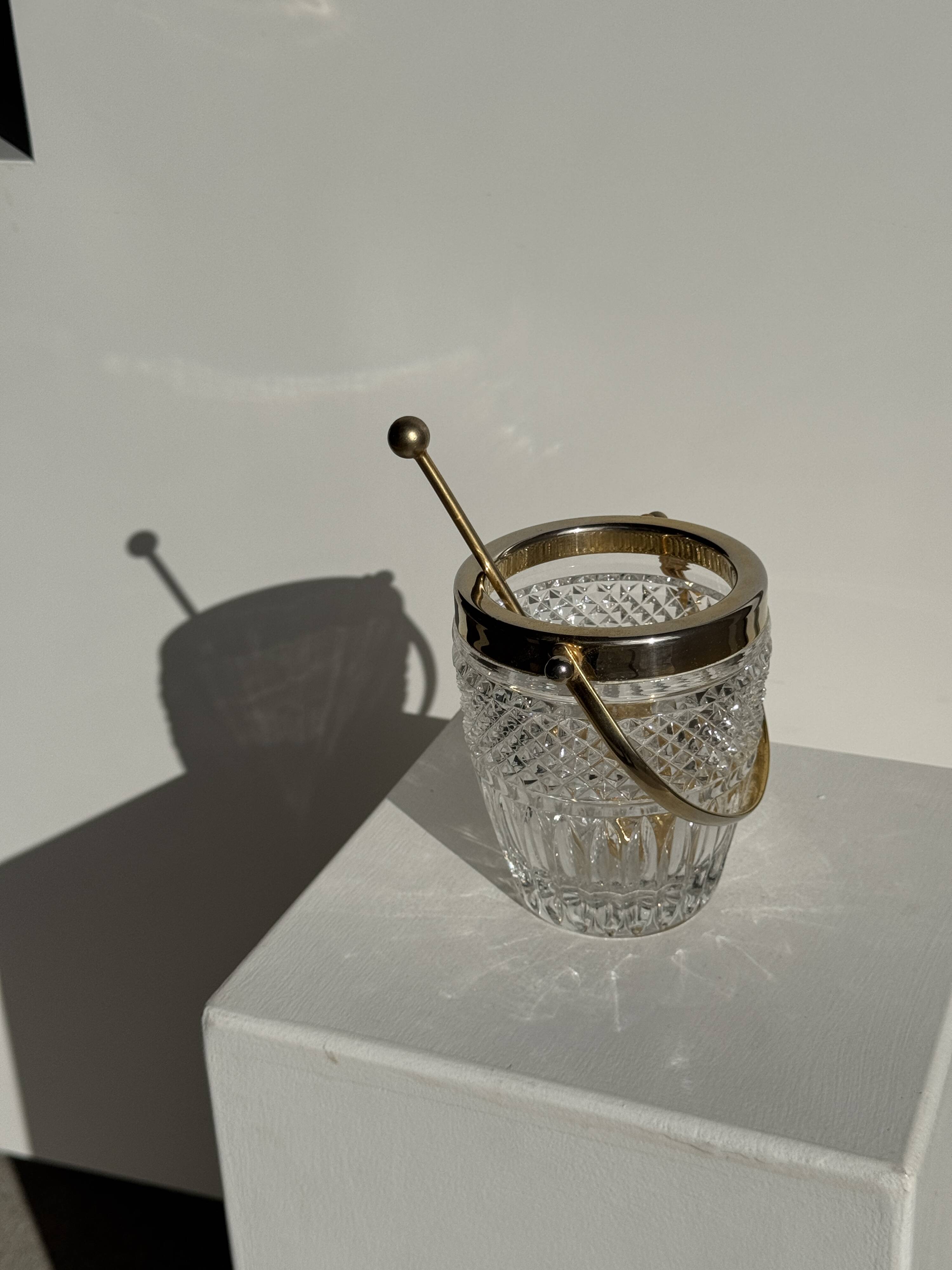 Small golden glass ice bucket with diamond point design and its scoop.