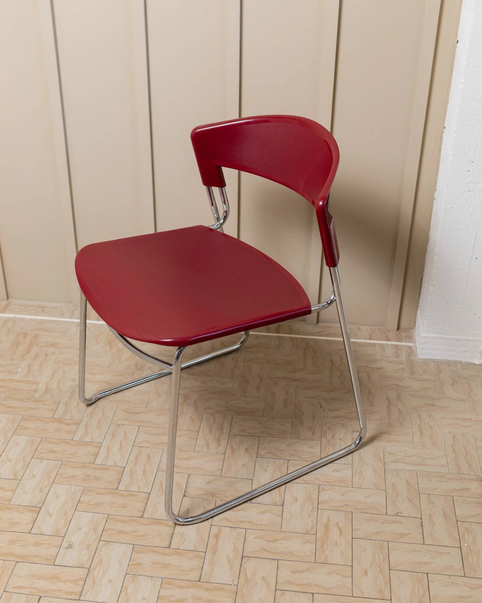 Vintage dining chair from the 1980s by Paolo Favaretto for Assisa, stackable, design Italy 1986 - chrome and red plastic - a classic of design.