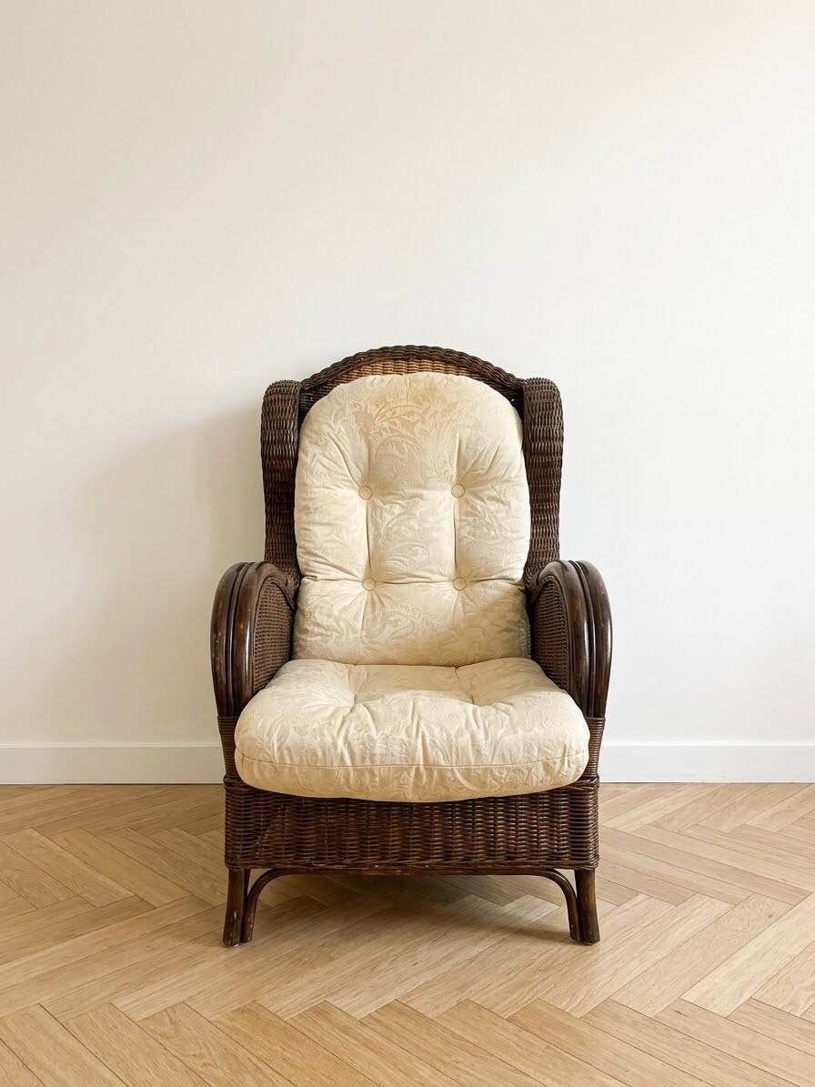 Vintage armchair in rattan and wicker with beige cushion.