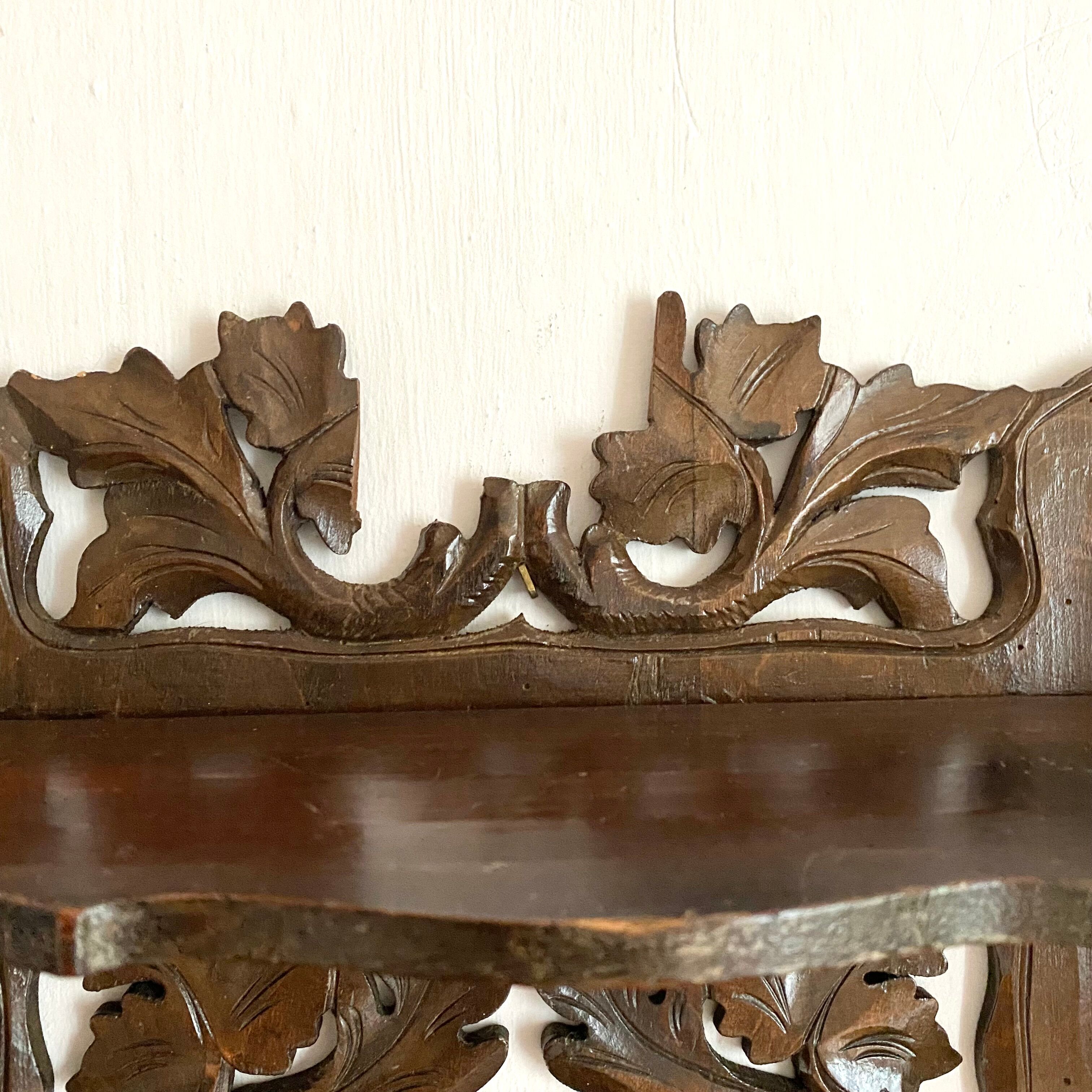 Carved wooden wall shelf