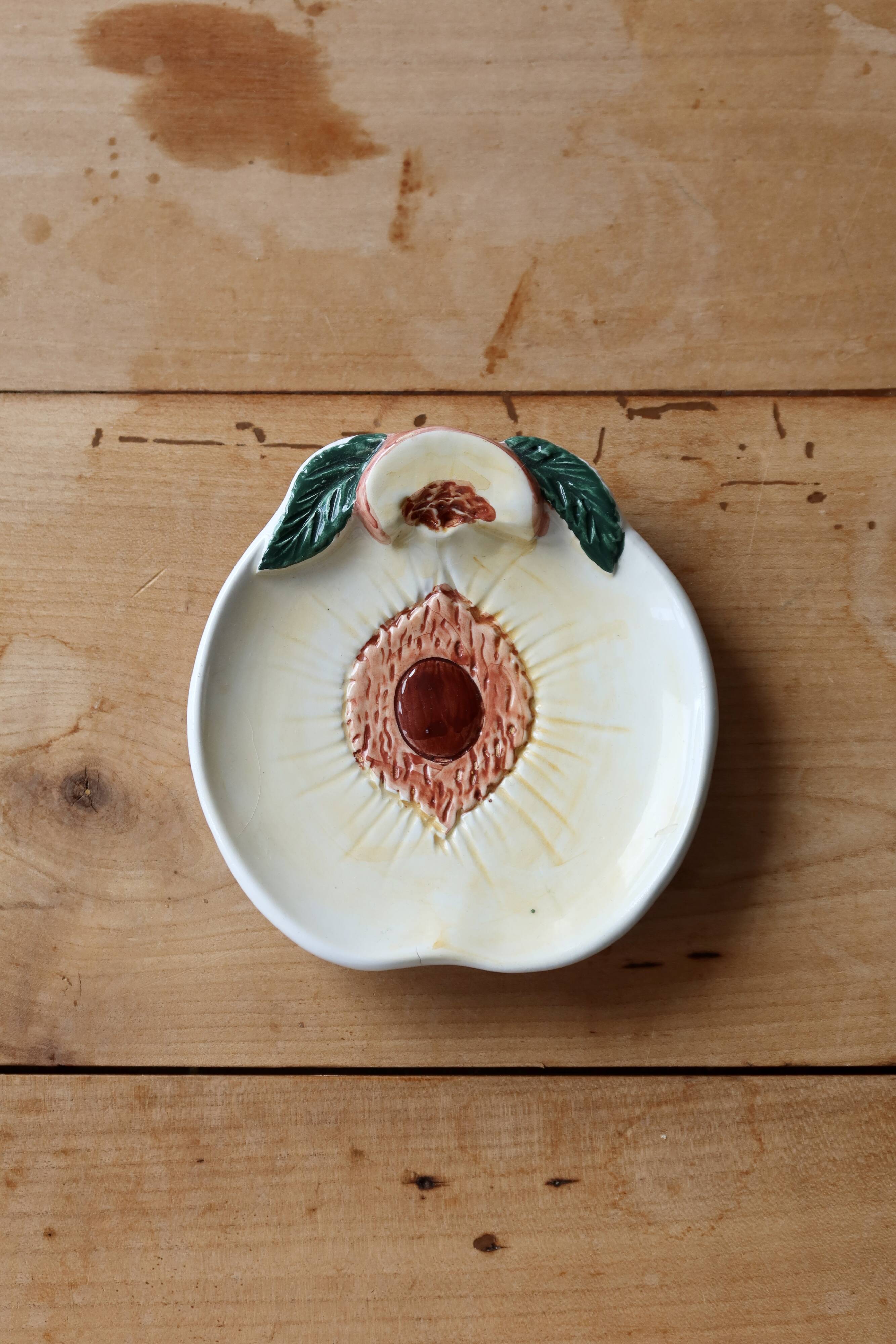 Small vintage barbotine bowl with peach-shaped pattern