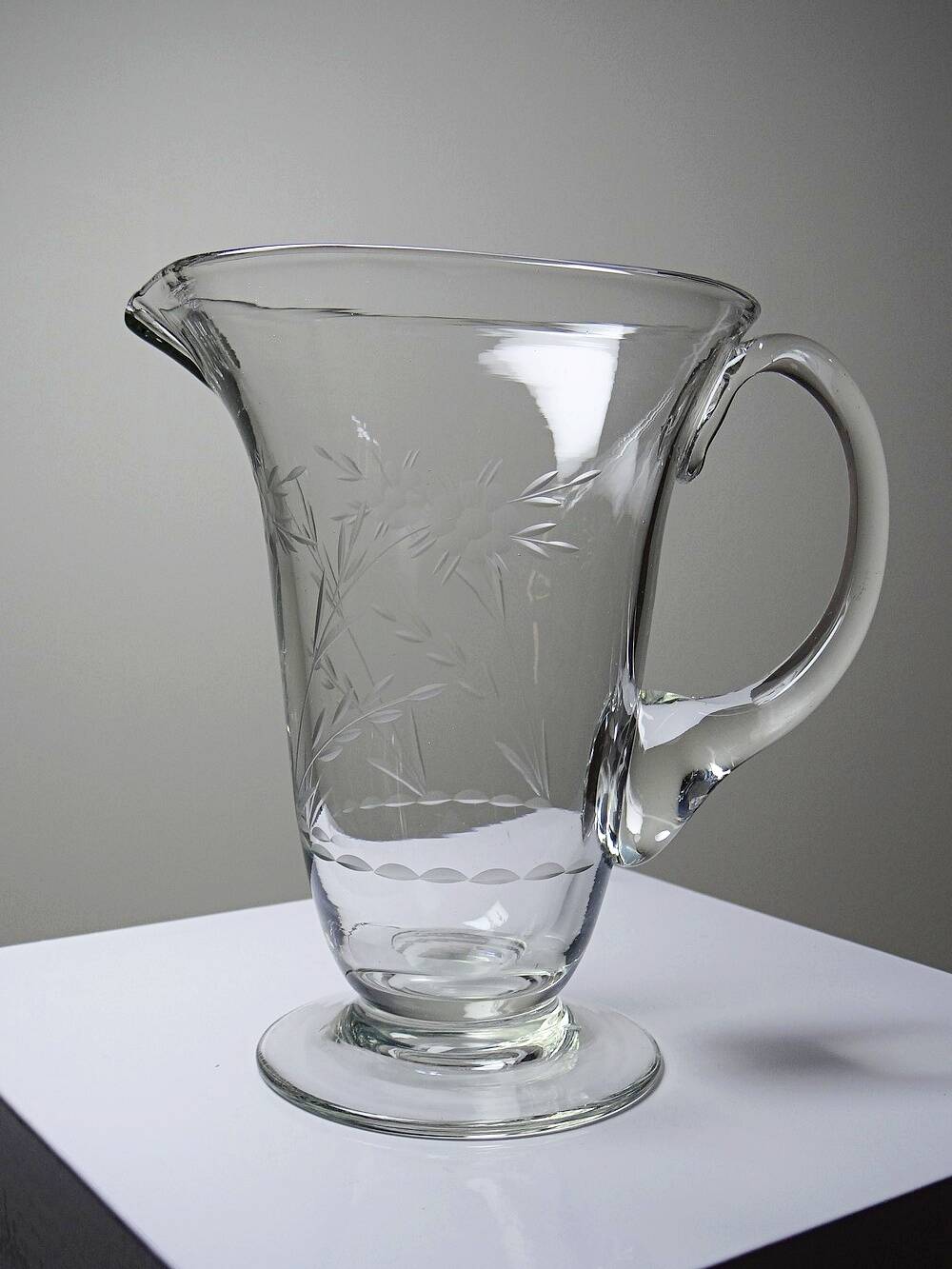 Antique glass pitcher with wheel engraving and floral decoration, Bohemia, early 20th century.