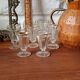 Antique footed liqueur glasses with gold trim from the early 20th century.