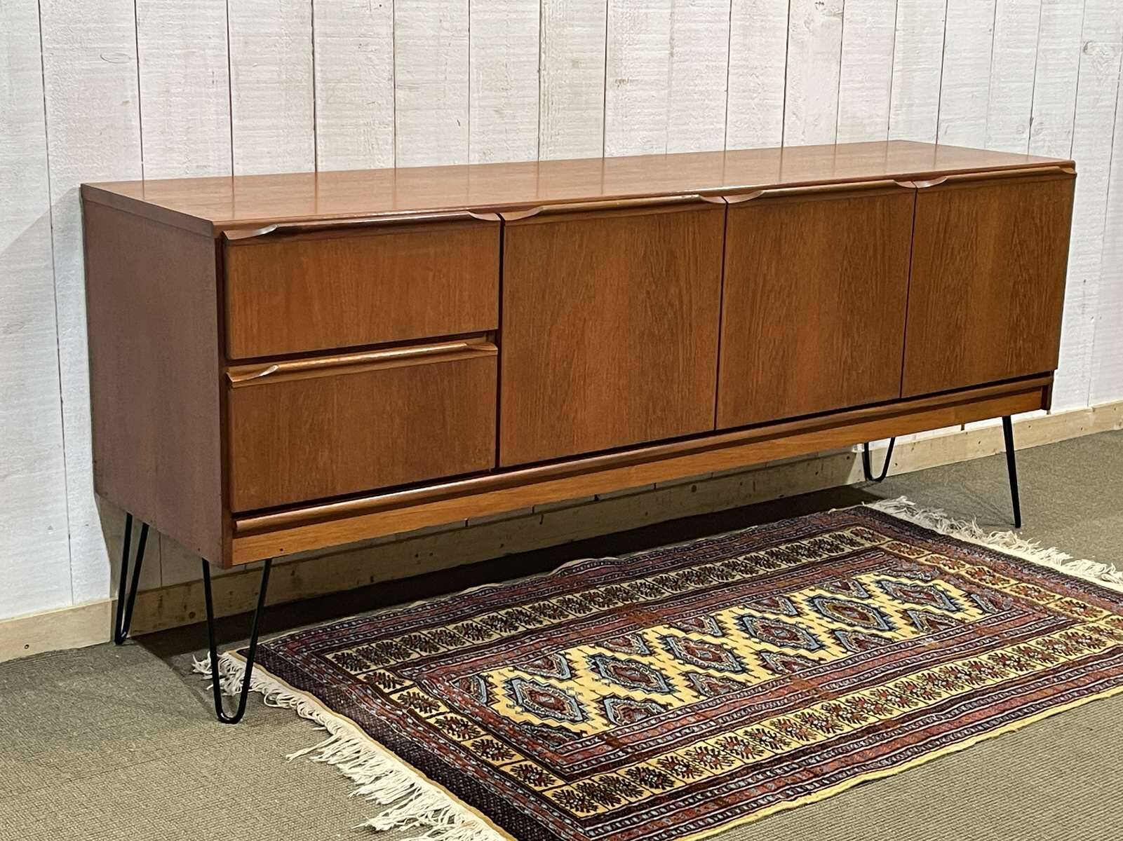1970s English enfilade in teak with splayed legs.