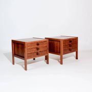 Pair of vintage Scandinavian bedside tables, three drawers, honey-toned wood.