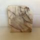 Asymmetrical marble ashtray emptier