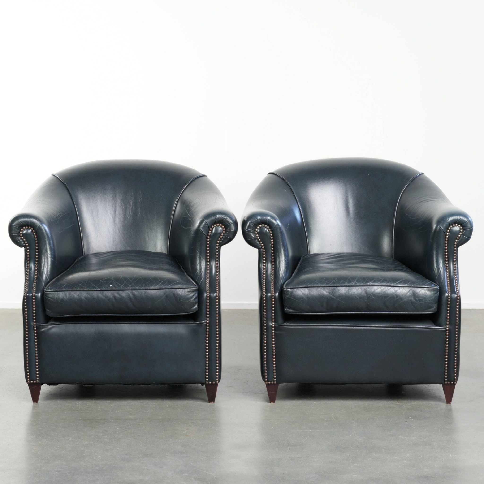 Set of dark blue cow leather club armchairs with a unique design