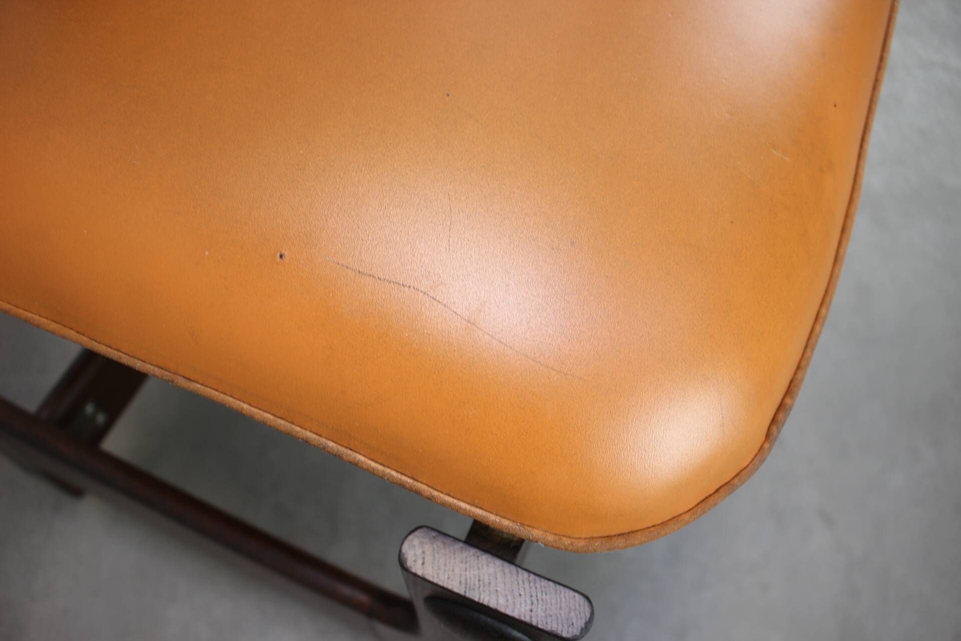 Vintage German sculptural chair from the 1970s in wood with orange faux leather.