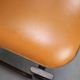 Vintage German sculptural chair from the 1970s in wood with orange faux leather.