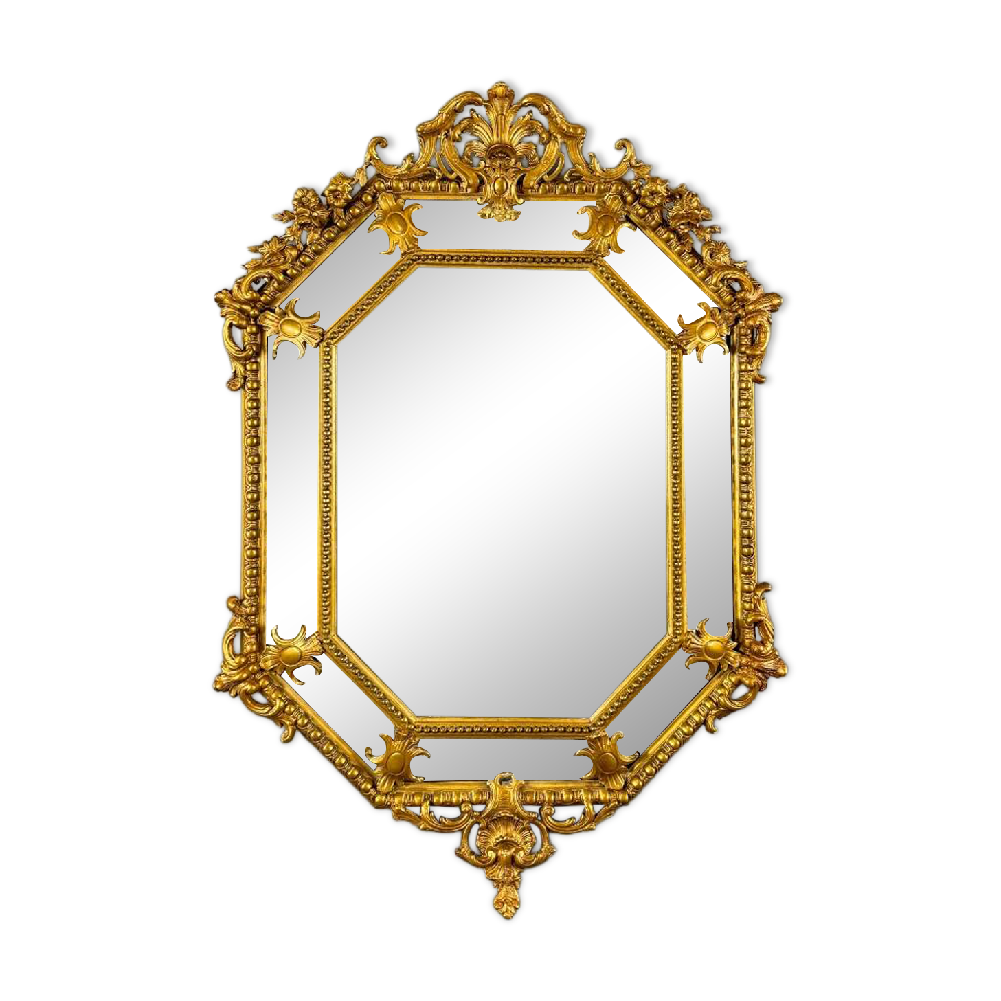 Antique octagonal mirror in richly carved gilded wood, Louis XV style.