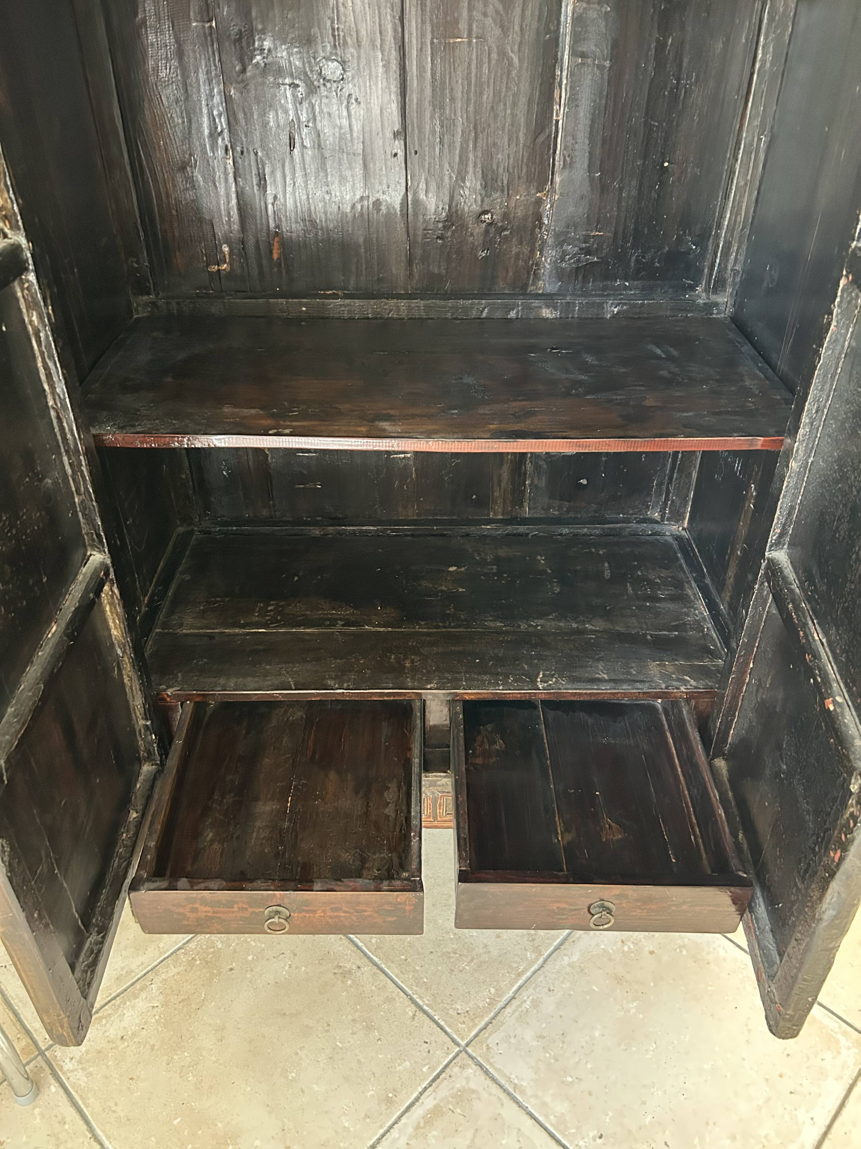 Antique Chinese wardrobe in carved elm.