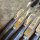 12 blackened wooden knives