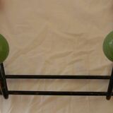 Small wrought iron coat rack with wooden balls.