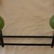 Small wrought iron coat rack with wooden balls.