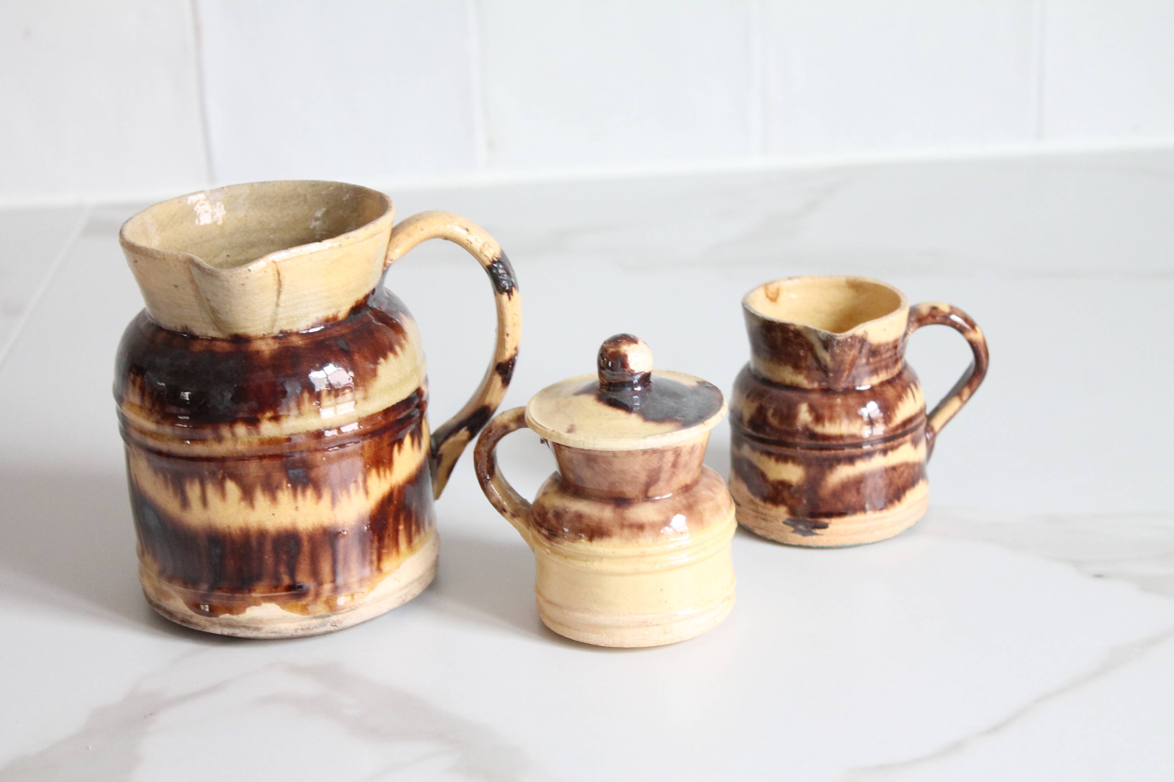 3 old bicoloured enamelled stoneware jugs