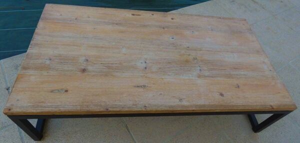 Table basse de style industrielle à plateau de bois supporté par un piètement métallique-