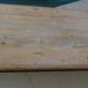 Industrial style coffee table with wooden top supported by a metal base -