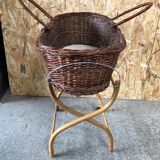 Old woven wicker baby cradle