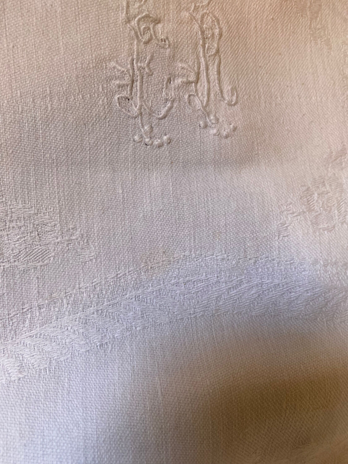 Pair of embroidered white cotton tea towels.