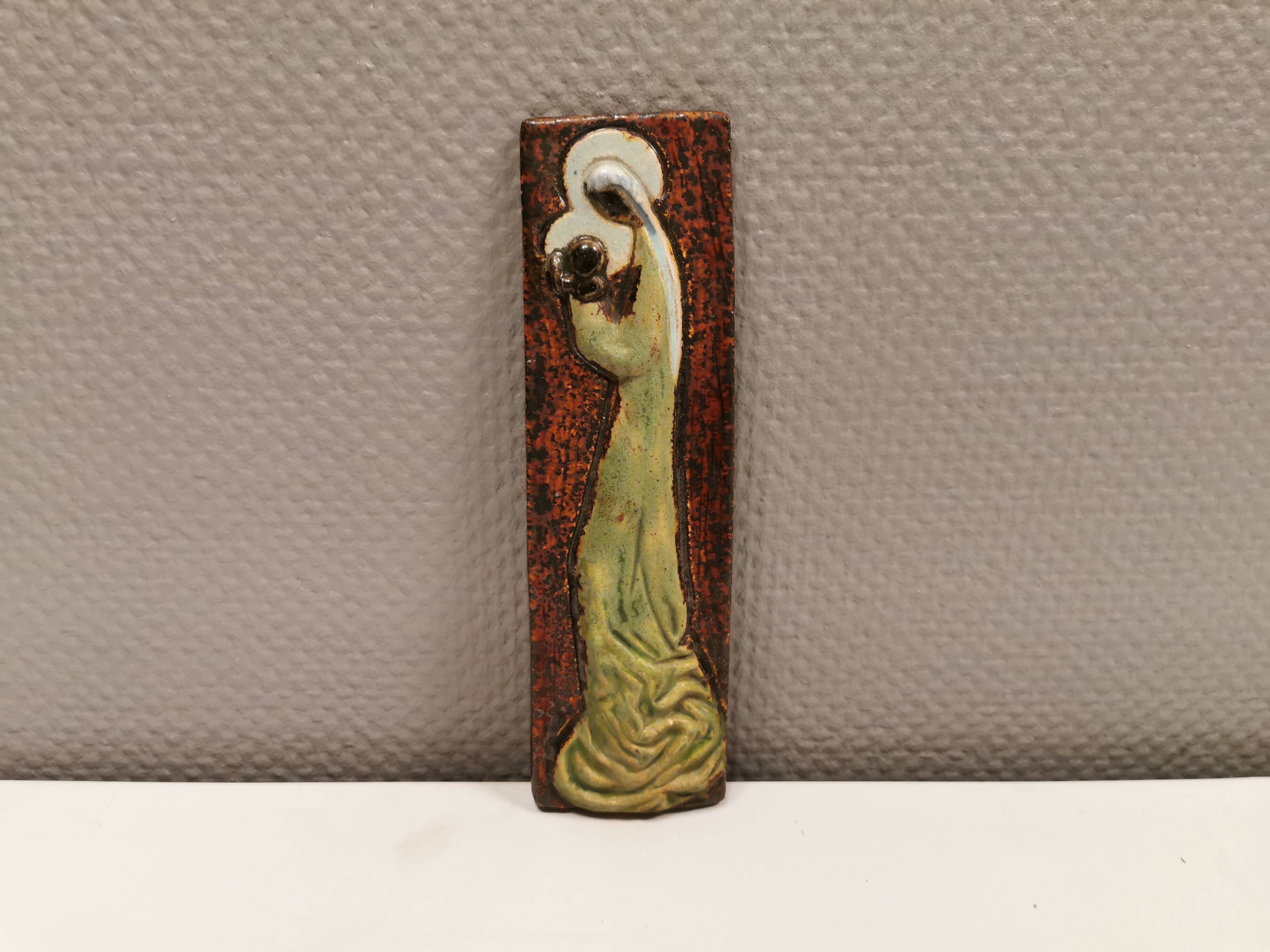 Slim relief with a motif of Madonna and child.