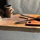 Small rectangular teak monoxyle cutting board with a circular handle.
