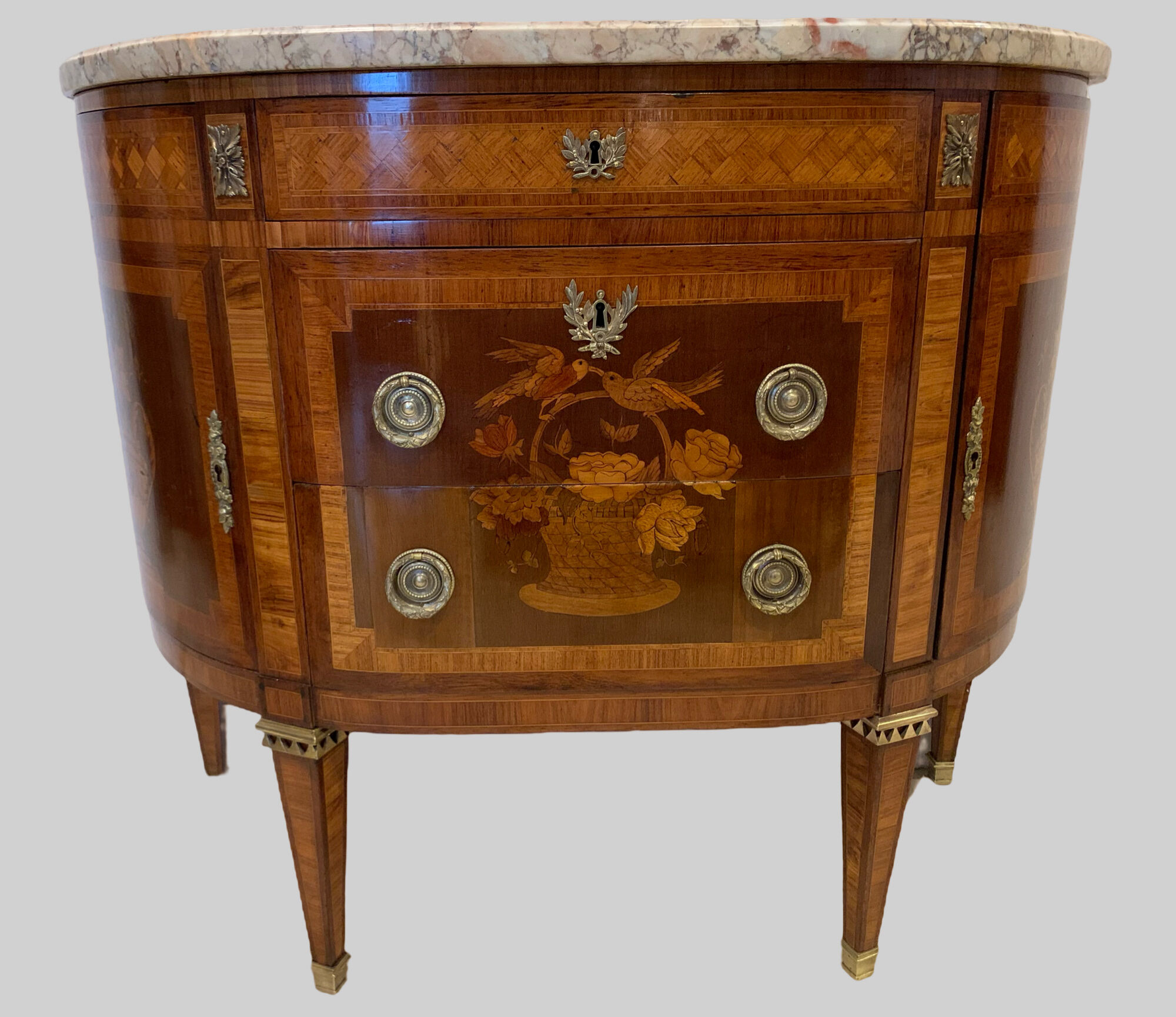 Louis XVI style half-moon chest of drawers in late nineteenth century marquetry
