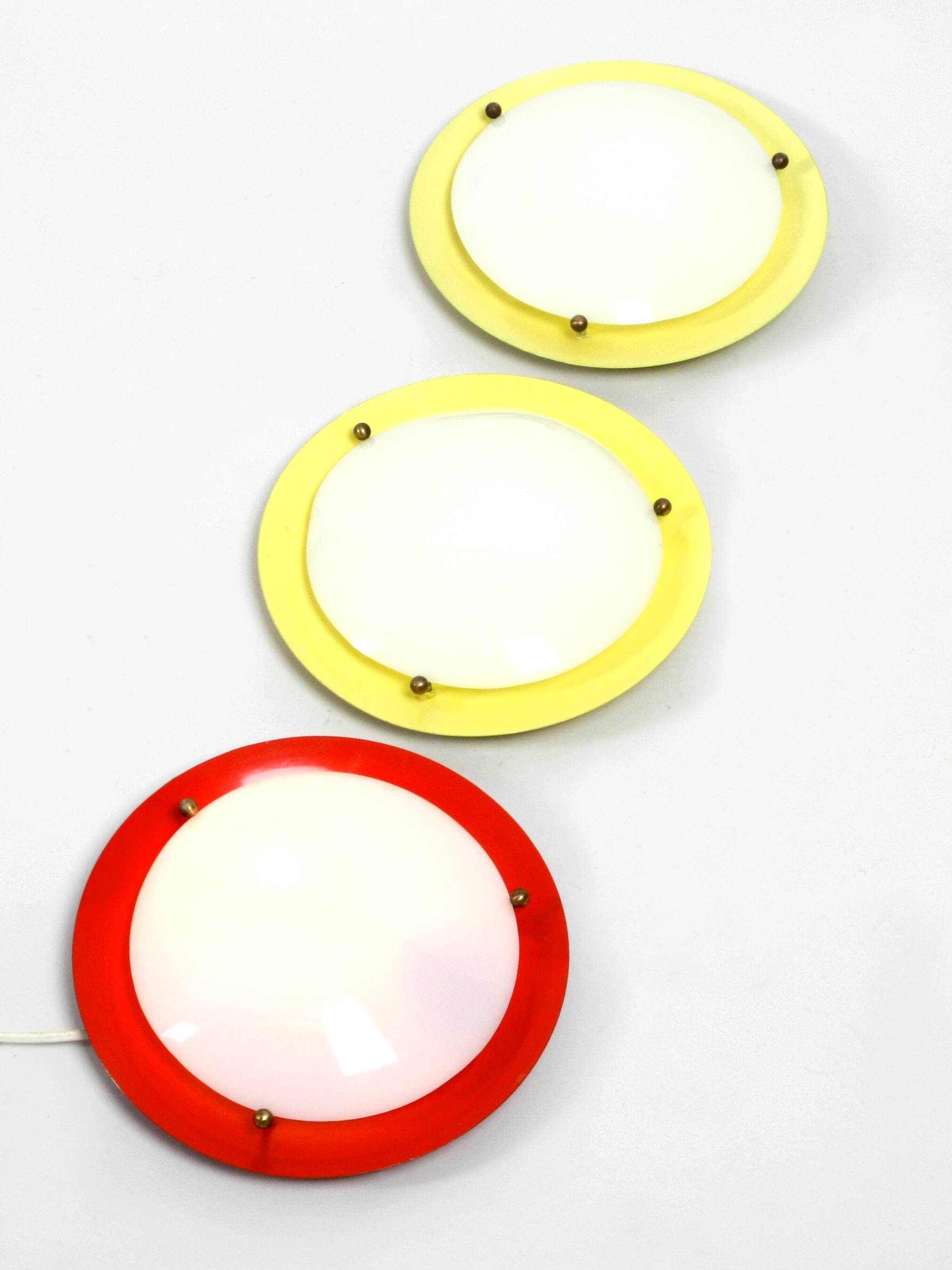 Three round 1950s wall or ceiling lamps made of metal and plexiglass shades