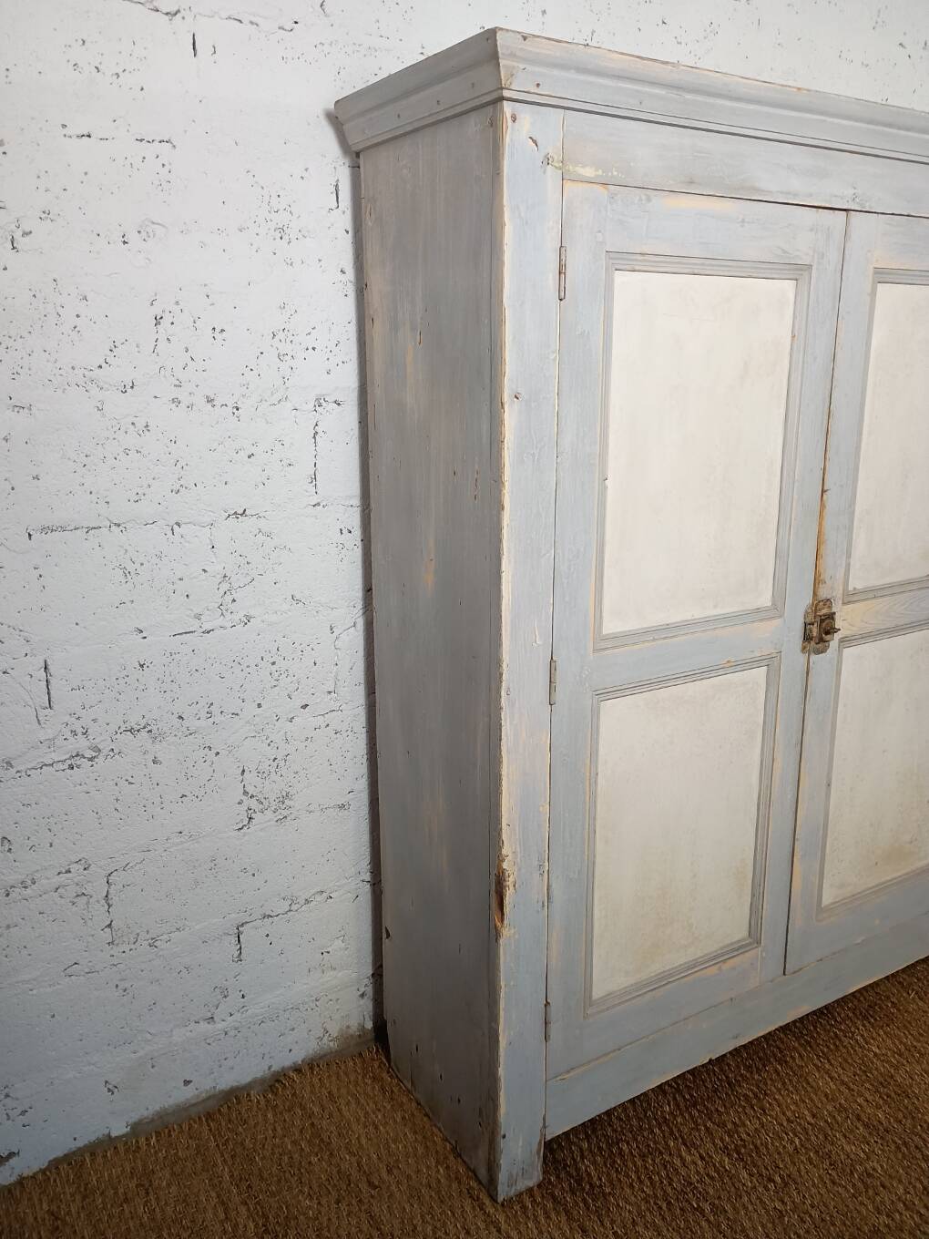 Low Parisian wardrobe with two doors, made of fir with original patina