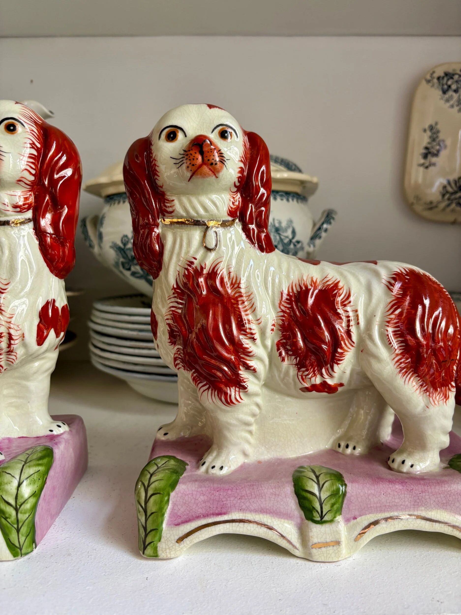 Pair of Staffordshire porcelain Cavalier King Charles dogs on terrace, 19th century.