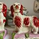 Pair of Staffordshire porcelain Cavalier King Charles dogs on terrace, 19th century.