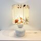 Vintage design lamp base in white ceramic with dried flower shade