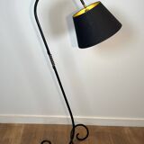 Design floor lamp in black lacquered metal and brass.