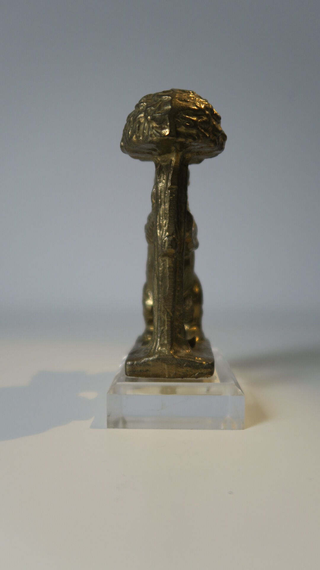 Brass sculpture, bear looking for honey in the tree