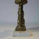 Brass sculpture, bear looking for honey in the tree