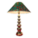 This elegant table lamp features a sculptural base in shiny gold brass.