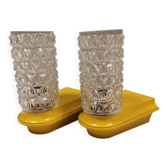 Bathroom lamps in a nice yellow colour with a crystal glass shade and a base of hard thin plastic