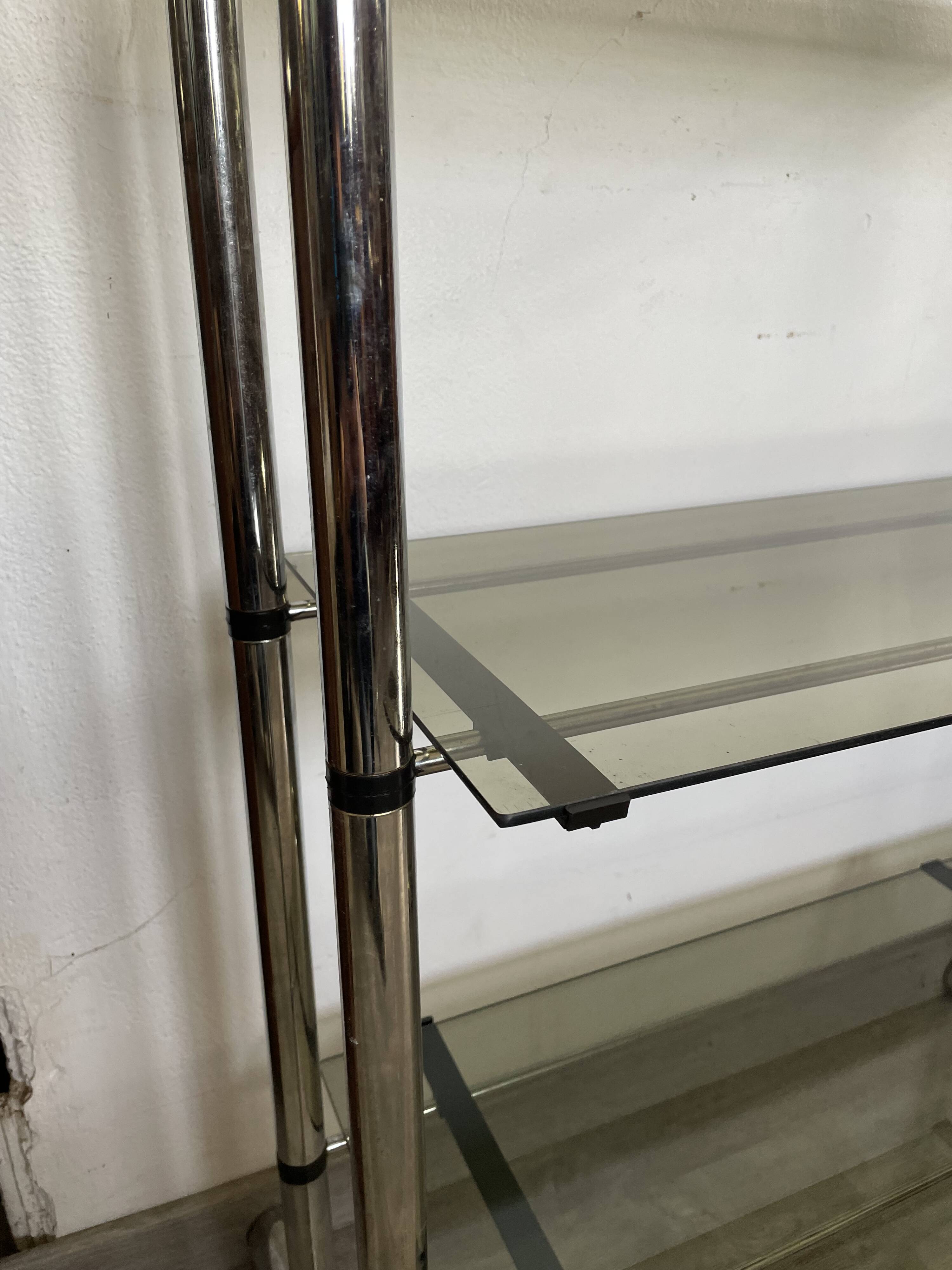 Chromed metal tubular shelf with smoked glass.