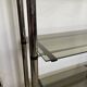 Chromed metal tubular shelf with smoked glass.