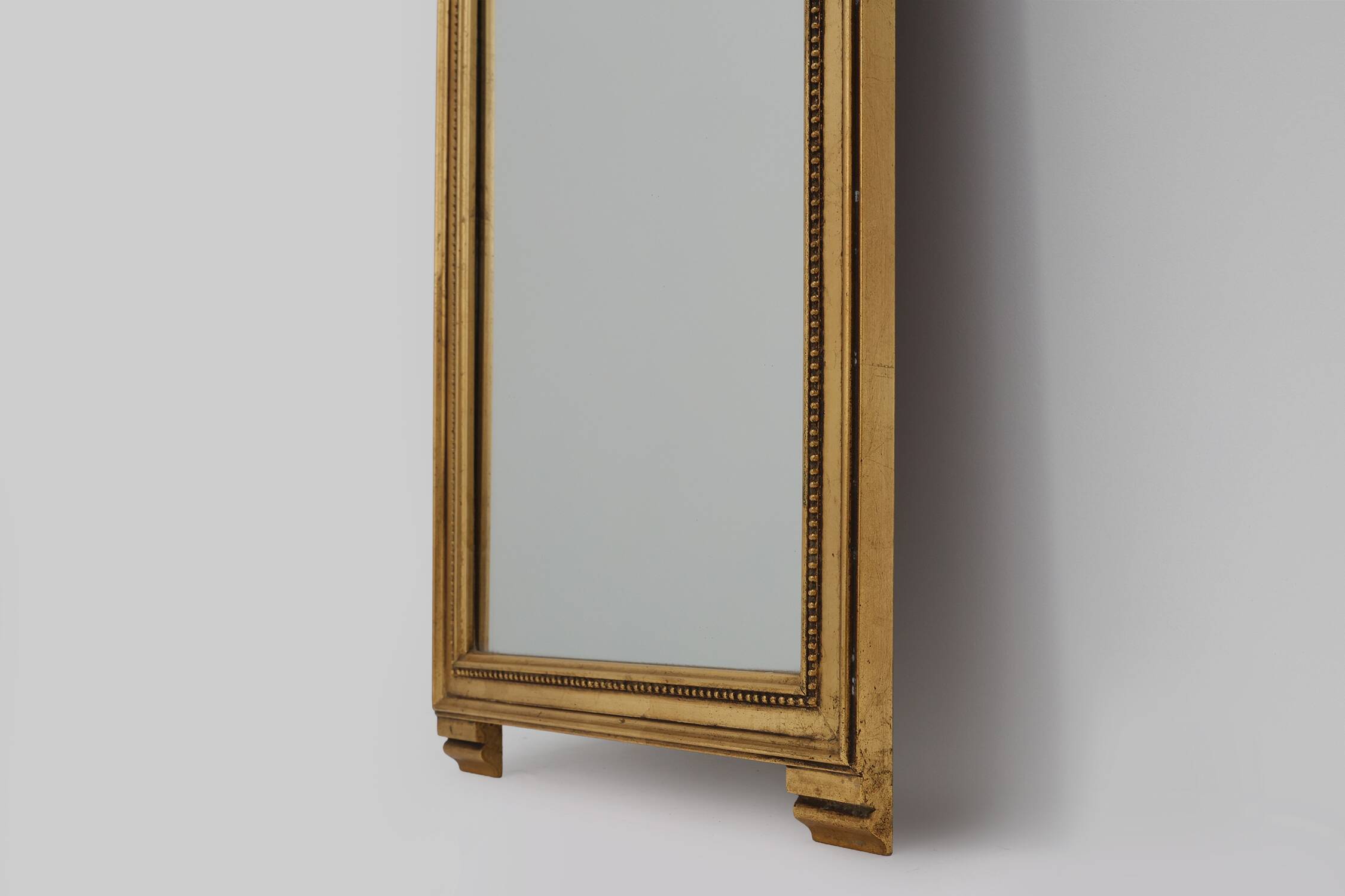 20th Century gilded wooden Empire style mirror with eagle on top