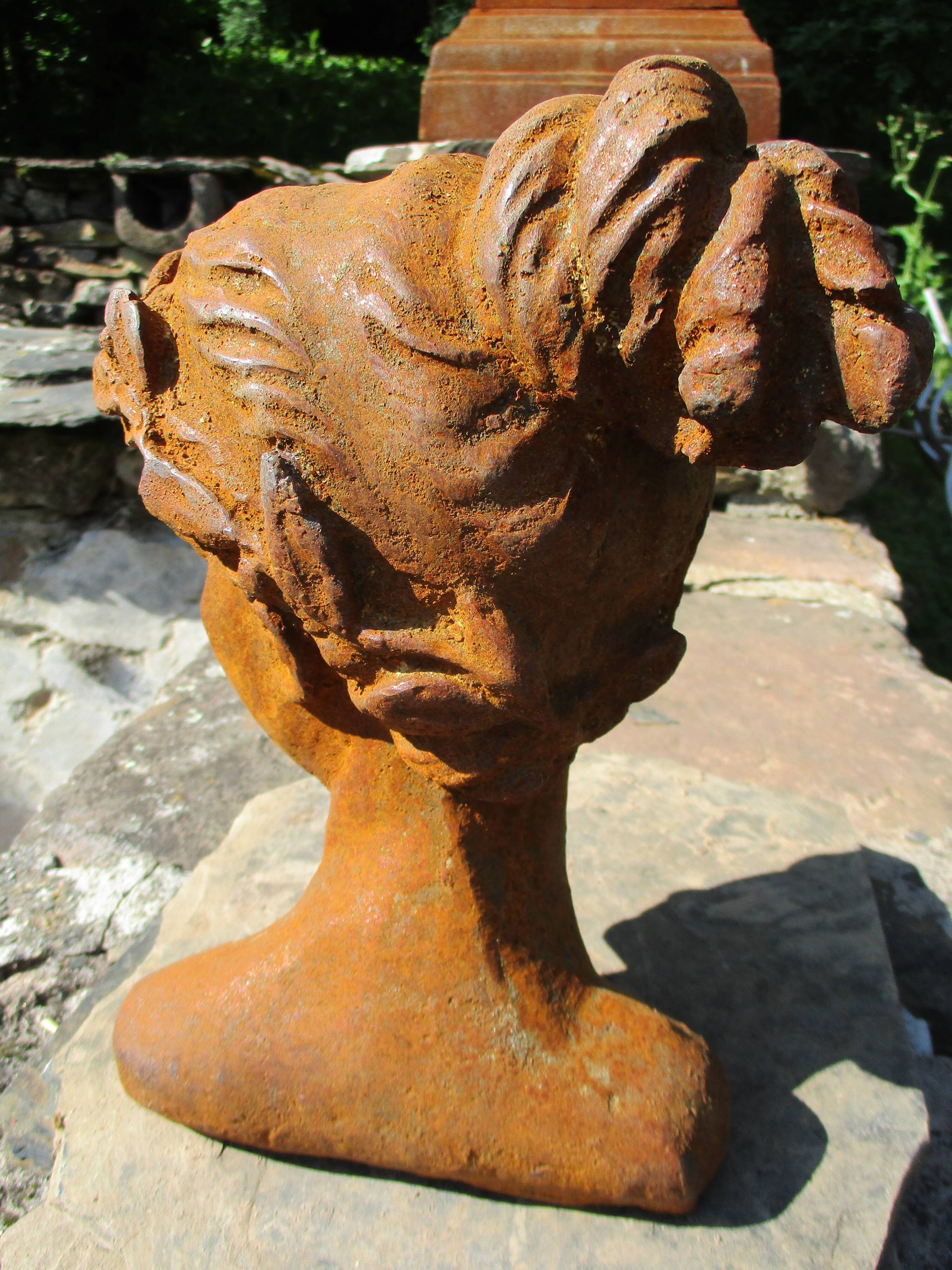 Cast iron sculpture of a woman.