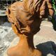 Cast iron sculpture of a woman.