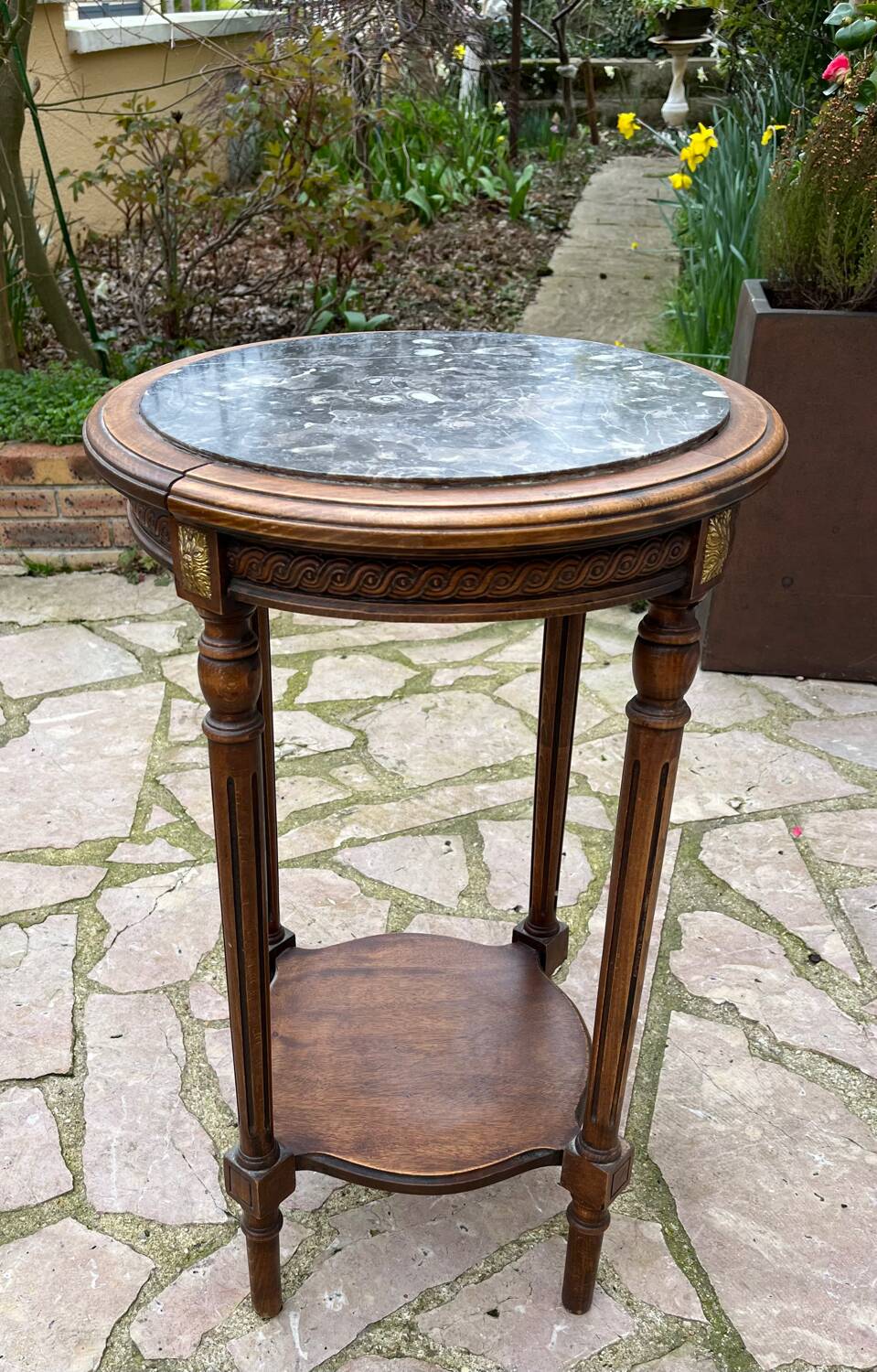 Old wooden pedestal table with marble top